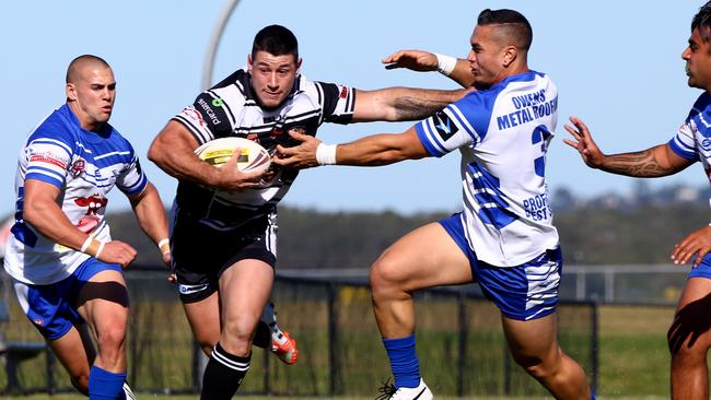 Coast 2 Coast Cup rugby league at Tugun. Tugun Seahawks v Tweed Heads Seagulls. Tweeds #4 Tim Cassidy palms off Tuguns #3 Tim Matenga. Photo: Kit Wise