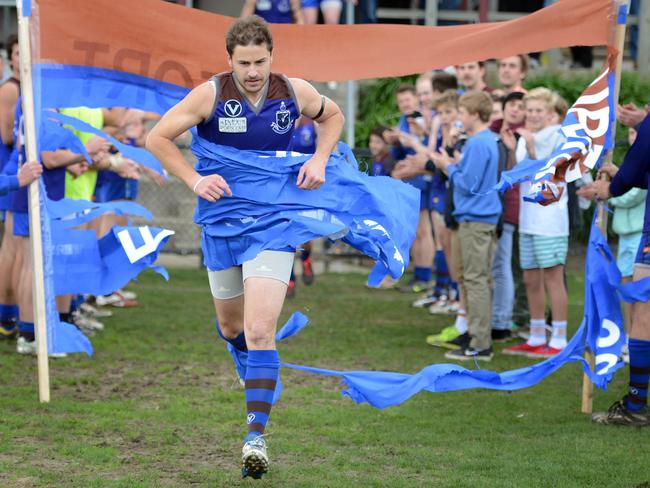 Payze runs through a banner for his 300th game in 2013.