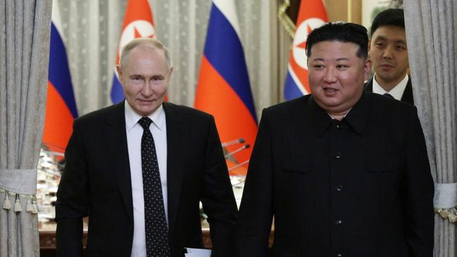 Russian President Vladimir Putin (L) and North Korea’s leader Kim Jong Un arrive for a meeting at Kumsusan state residence in Pyongyang.