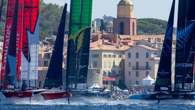 Canada SailGP Team helmed by Phil Robertson lead the SailGP Fleet as they sail past the bell tower and old town of Saint-Tropez. Picture: Ian Walton for SailGP.