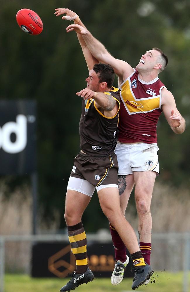 Lower Plenty captain Patrick Flynn climbs above Thomastown ruckman Dylan Chapman to win a hitout. Picture: Hamish Blair