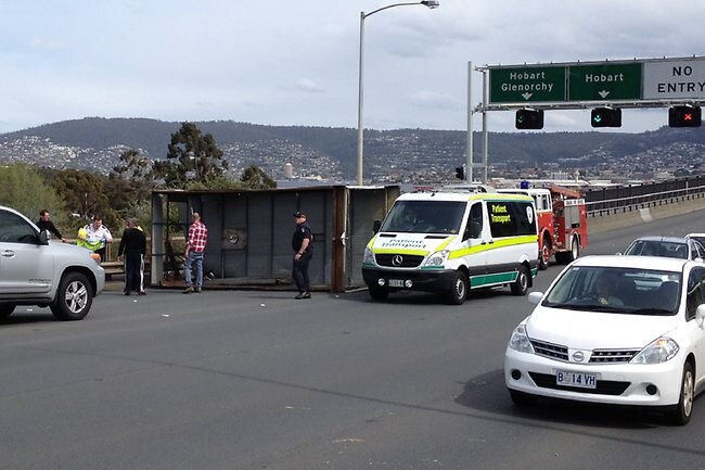 The back of a small rubbish truck blew off on the Tasman bridge creating traffic chaos for city-bound traffic.