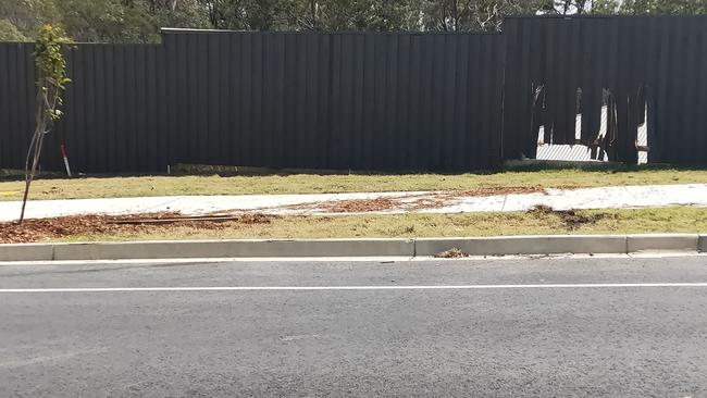 A fence damaged along George Alexander Drive at Coomera were locals say they are fed up with hoons driving dangerously and destroying their property. 