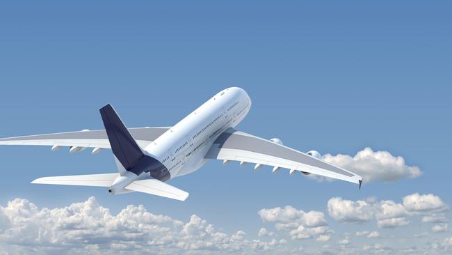 airplane in the sky seen from behind with copy space in the top and a clipping path in the plane