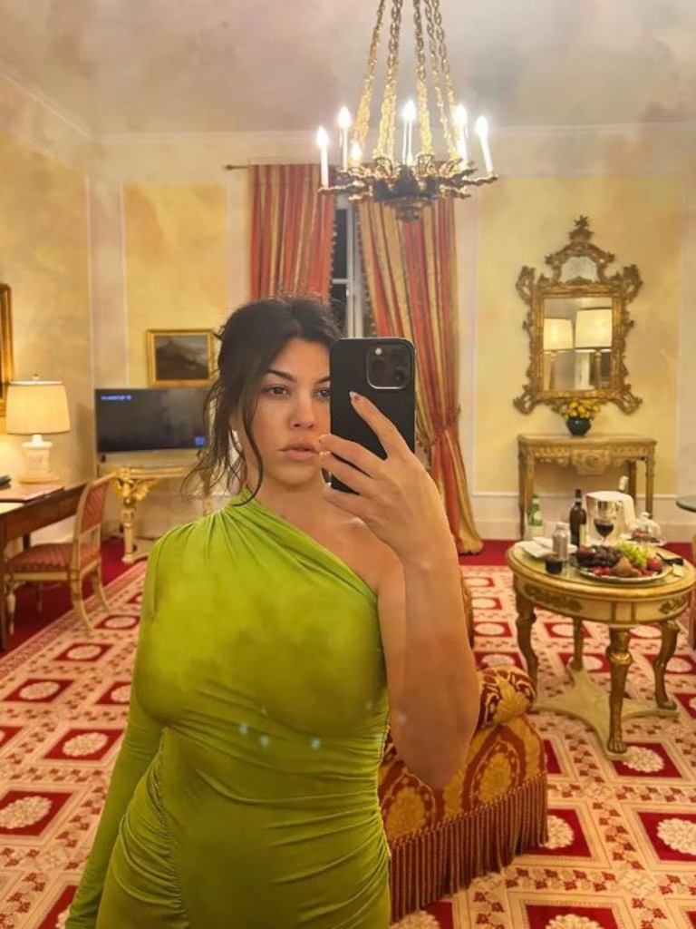 Kourtney Kardashian went braless in a neon green dress for her latest date night with Travis Barker. Picture: Instagram/kourtneykardas.