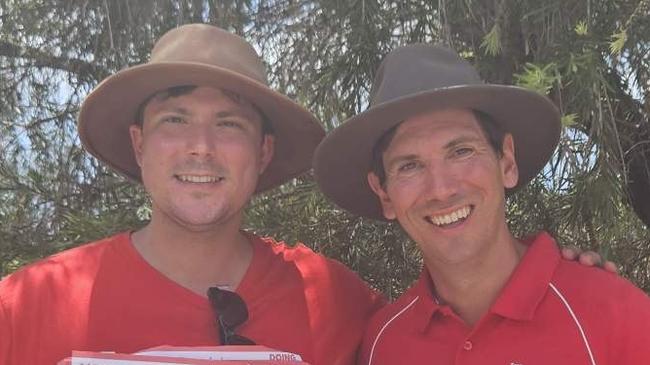 Bundaberg Labor MP Tom Smith, who voted Friday, with one of his booth volunteers as the incumbent continued campaigning on election day.