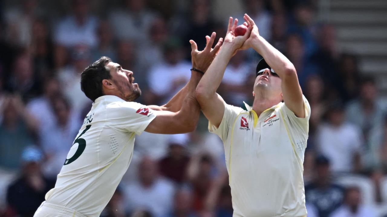 Mitchell Starc (L) collides with Pat Cummins (R) as the Australian captain takes a catch to dismiss Harry Brooks. Picture: AFP