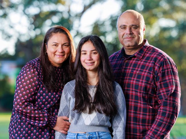 Daily Telegraph. 23, May, 2024.Dany and Cynthia Elachi, with their daughter Aalia, 14, at home, in Bexley, Sydney, today. Aalia is not allowed social media or a phone. Picture: Justin Lloyd.