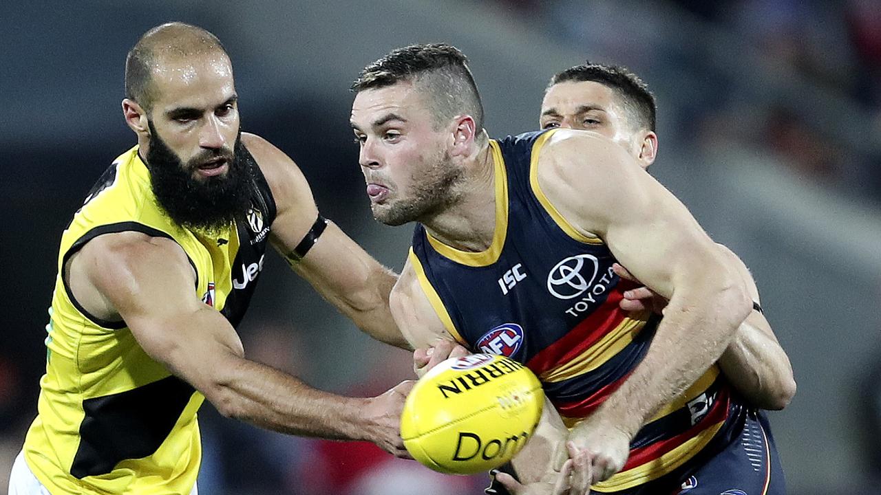 Adelaide’s Brad Crouch under pressure from Richmond’s Bachar Houli. Picture: Sarah Reed