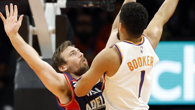 : Devin Booker #1 of the Phoenix Suns shoots over Mitch McCarron #10 of the Adelaide 36ers Chris Coduto/Getty Images/AFP