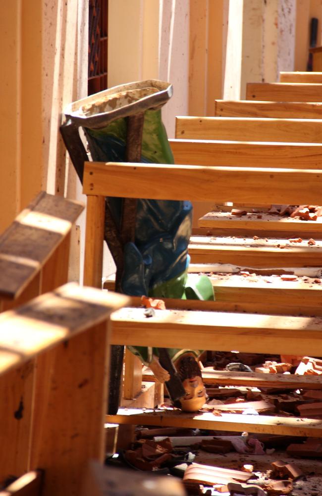 A statue Jesus Christ knocked over amid blast debris at St Sebastian's Church in Negombo. Picture: AFP