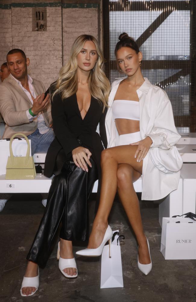 Influencers Emily Venz and Isabelle Mathers couldn’t look more ready for their front row moment – the guy back in second row, not so much. Picture: Brook Mitchell/Getty Images