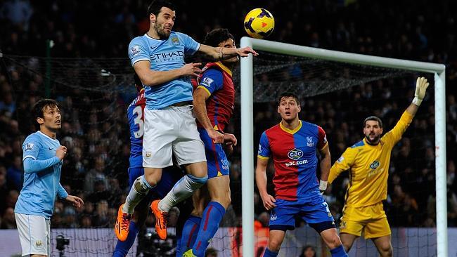 Mile Jedinak vies with Alvaro Negredo.