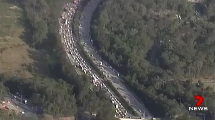 M1 chaos after gravel truck loses load - 7 News Queensland