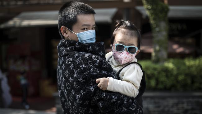 A father and child wear face mask in Wuhan, China. Picture: Getty Images