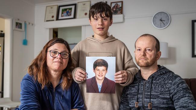 The Elmes family holding a photo of Joshua Elmes who died in the Bochara crash. Picture: Jake Nowakowski