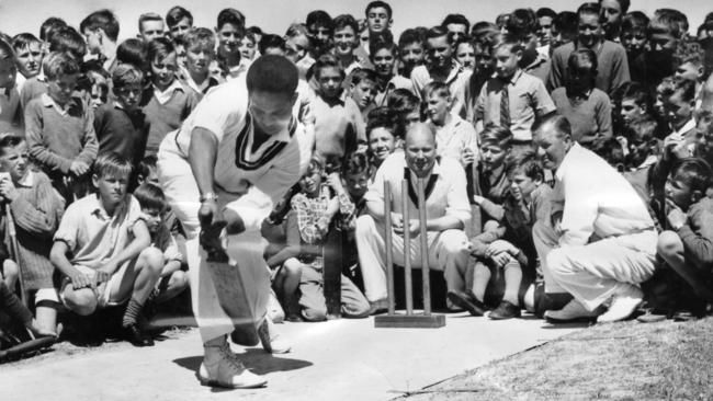 West Indian cricket legend Garfield Sobers demonstrates his left-handed technique for some Adelaide schoolboys in 1961.