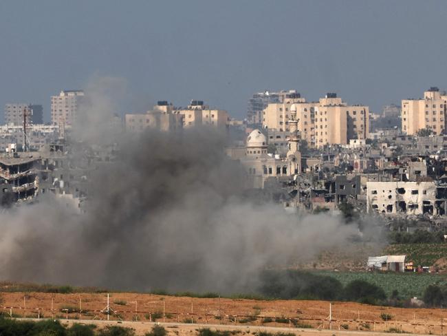 A picture taken from the Israeli side of the border with the Gaza Strip on October 15, 2023, shows smoke billowing after Israeli bombardment of an area in the north of the Palestinian enclave. Israeli forces were on October 15, readying for a looming Gaza ground invasion aimed at destroying Hamas, the Palestinian Islamist militant group that unleashed the bloodiest attack in the country's history. (Photo by JACK GUEZ / AFP)