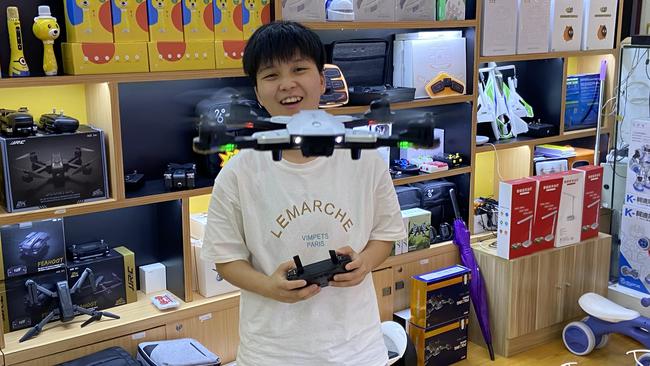 Toy seller Li Xiaohua demonstrates a Drone Pro in the store where she works in Shenzhen, in China's southern province of Guangdong. Picture: Will Glasgow