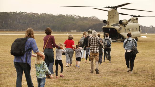 Last of the remaining evacuees airlifted out of Mallacoota Airport by Army chinook helicopters bound for Sale. Picture: David Caird