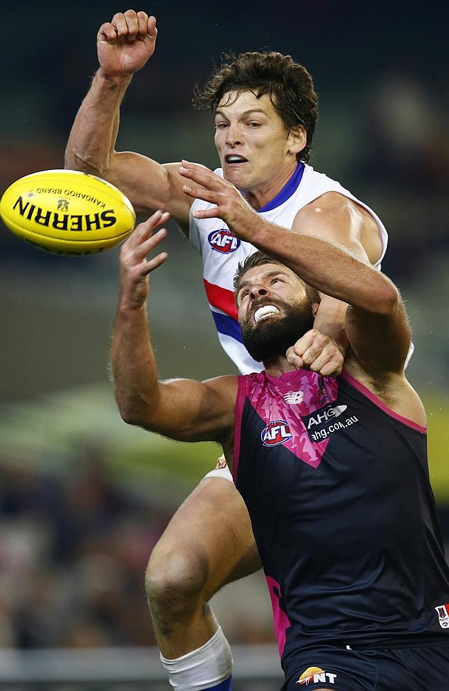 Bulldogs ruckman Will Minson jumps over Demon Mark Jamar. Picture: Michael Klein