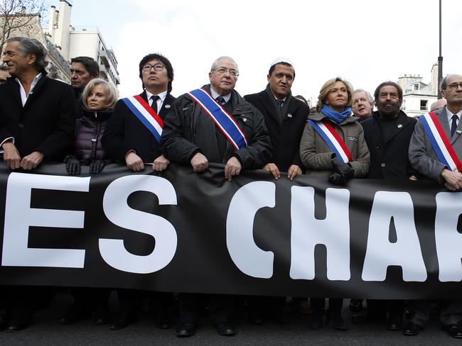 Solidarity ... French writers, muslim leaders and politicians hold a banner reading ‘Nous sommes Charlie’ (We are Charlie) in Paris before the start of a Unity rally. Picture: AFP/Thomas Samson