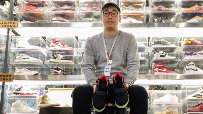 Store manager Guan Tian, 25, at his high-end Beijing sneaker shop. Picture: WSJ