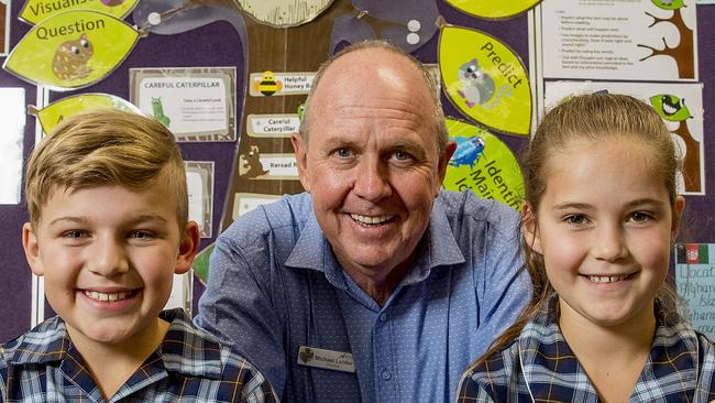 Assisi Catholic College students, Ethan Naimo, 10, Principal Michael Laidler and April McFaul, 8. Picture: Jerad Williams