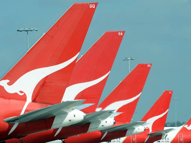 **FILE** A Dec. 3, 2008 file photo of the tails of Qantas jets at Sydney International Airport. Qantas Airways Ltd's first-half profit slumped 66 per cent, Wednesday, Feb. 4, 2009, as fuel and labour costs buffeted Australia's biggest airline. (AAP Image/Dean Lewins,File) NO ARCHIVING