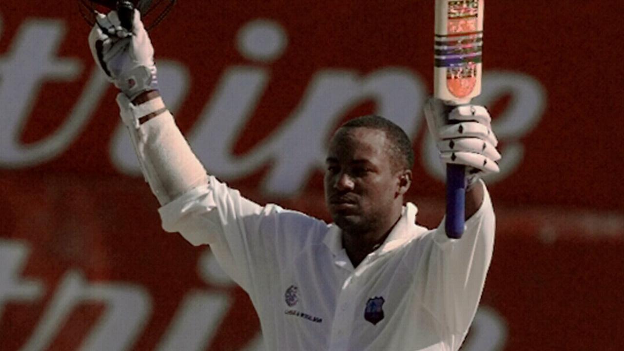 APRIL 4, 1999 : West Indies captain Brian Lara raises bat after hitting century during Fourth Test of series against Australia at Antigua Recreation Ground in St Johns 04/04/99. Cricket Cricket F/L