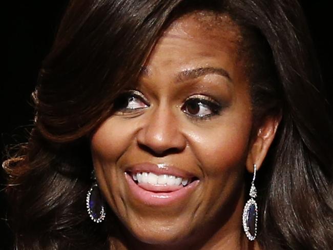 US First Lady Michelle Obama gives an address during a visit as part of the US government's 'Let Girls Learn' initiative at Mulberry School for Girls in east London on June 16, 2015. On the first full day of a visit to Britain the US First Lady met with local students in east London and discussed how Britain and the US are working together in order to attempt to expand access to adolescent girls' education around the world. While in London, the First Lady will also host a roundtable meeting on Let Girls Learn, and meet with British Prime Minister Cameron, Samatha Cameron, and Prince Harry. AFP PHOTO / JUSTIN TALLIS