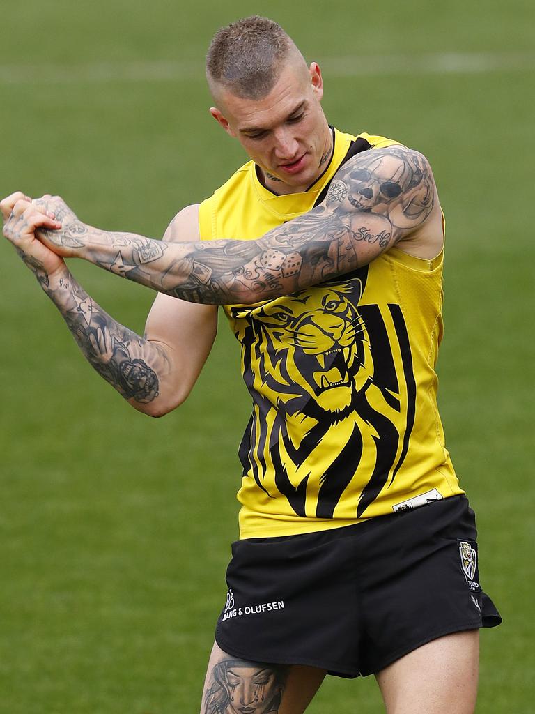 Dustin Martin practises his golf swing at training. Picture: Michael Klein.