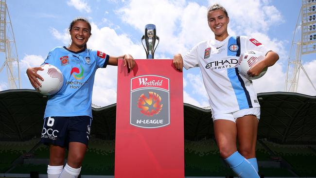 Sydney FC captain Teresa Polias and Melbourne City captain Steph Catley with the W-League trophy.