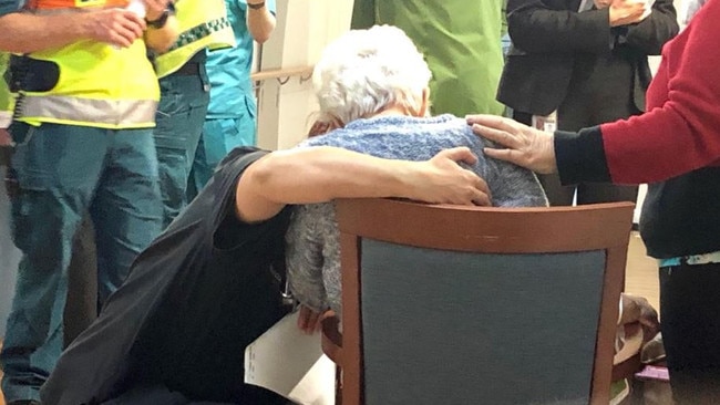 A resident is comforted as last night's rescue operation at Earle Haven nursing home.