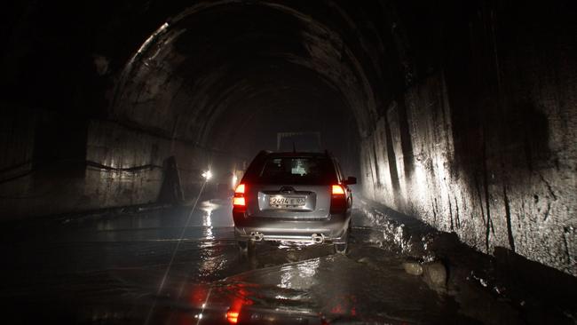 The Anzob Tunnel is dark, full of emissions and flooded. Picture: Julian G Albert