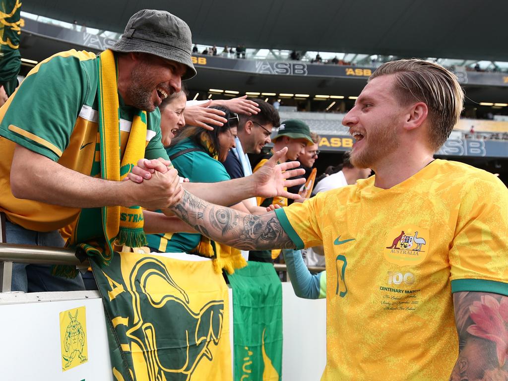 Socceroos goalscorer Jason Cummings is congratulated by a fan after Australia’s win. Picture: Fiona Goodall/Getty Images