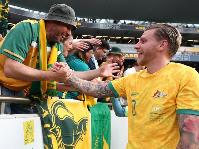 Socceroos goalscorer Jason Cummings is congratulated by a fan after Australia’s win. Picture: Fiona Goodall/Getty Images