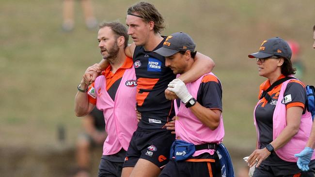 Will Setterfield is helped from the field after injuring his knee. Picture: Jonathan Ng