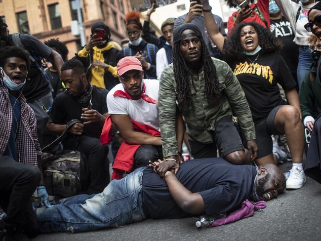 Protesters re-enact the scene of George Floyd’s death during a New York protest. Picture: AP