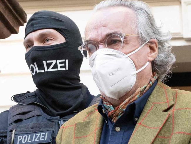 German special police forces detain Heinrich XIII Prinz Reuss after searching a house in Frankfurt / Main, western Germany, on December 7, 2022 as part of nationwide early morning raids against members of a far-right "terror group" suspected of planning an attack on parliament. - More than 3,000 officers including elite anti-terror units took part in the early morning raids and searched more than 130 properties, in what German media described as one of the largest police actions the country has ever seen. The raids targeted alleged members of the "Citizens of the Reich" (Reichsbuerger) movement suspected of "having made concrete preparations to violently force their way into the German parliament with a small armed group", prosecutors said in a statement. (Photo by Boris Roessler / dpa / AFP) / Germany OUT