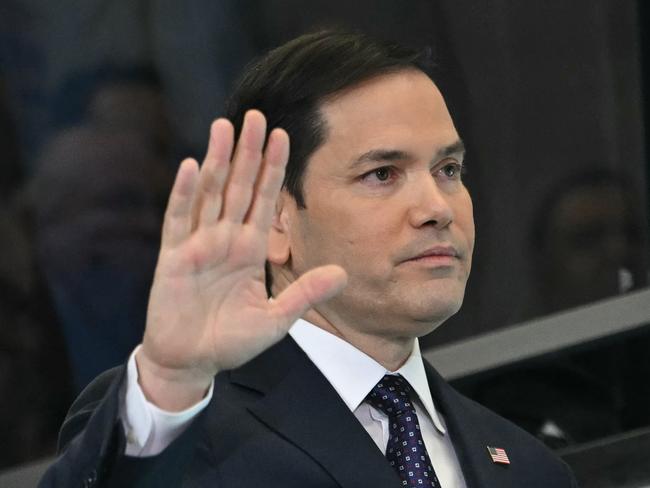 (FILES) US Secretary of State Marco Rubio waves to employees upon arrival at the State Department in Washington, DC, on January 21, 2025. The United States, the world's biggest donor, froze virtually all foreign aid on January 24, 2025Friday, making exceptions only for emergency food, and military funding for Israel and Egypt. Secretary of State Marco Rubio sent an internal memo days after President Donald Trump took office vowing an "America First" policy of tightly restricting assistance overseas. "No new funds shall be obligated for new awards or extensions of existing awards until each proposed new award or extension has been reviewed and approved," said the memo to staff seen by AFP. The sweeping order appears to affect everything from development assistance to military aid -- including potentially to Ukraine, which received billions of dollars in weapons under Trump's predecessor Joe Biden as it tries to repel a Russian invasion. (Photo by ANDREW CABALLERO-REYNOLDS / AFP)