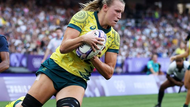 PARIS, FRANCE - JULY 30: Maddison Levi #12 of Team Australia scores her team's second try during the Women's Rugby Sevens Bronze medal match between Team United States and Team Australia  on day four of the Olympic Games Paris 2024 at Stade de France on July 30, 2024 in Paris, France. (Photo by Cameron Spencer/Getty Images)