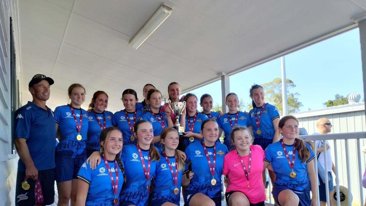 The South West Queensland Thunder under-15 girls celebrate their grand final win.