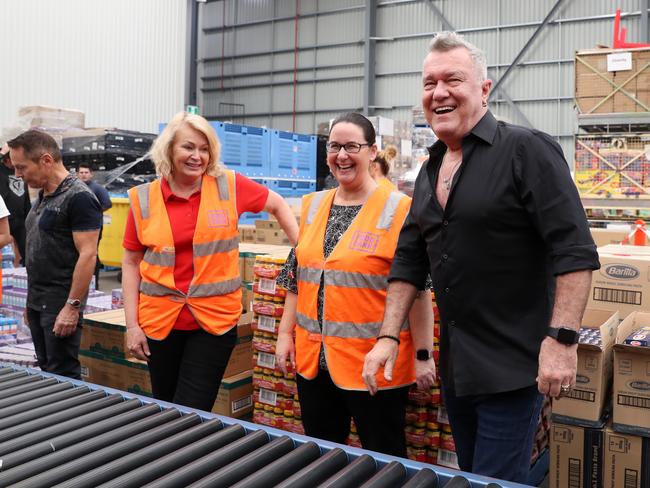 Cold Chisel Frontman Jimmy Barnes packs food packages with volunteers at the Foodbank warehouse. Picture: Jonathan Ng