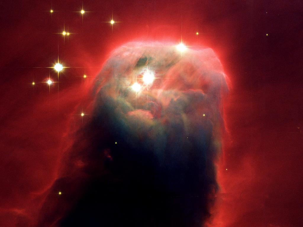 This is the Cone Nebula within the bright galactic star-forming region NGC 2264. Some have claimed this looks like an image of Jesus Christ. Radiation from hot stars off the top of the picture illuminates and erodes this giant, gaseous pillar. Additional ultraviolet radiation causes the gas to glow, giving the pillar its red halo of light.