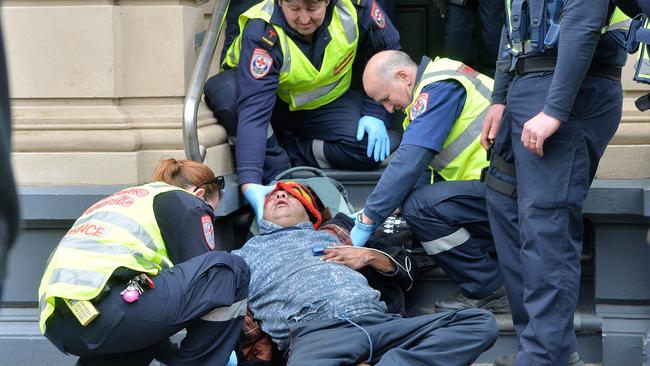 Paramedics with a protester. Picture: Rob Leeson.