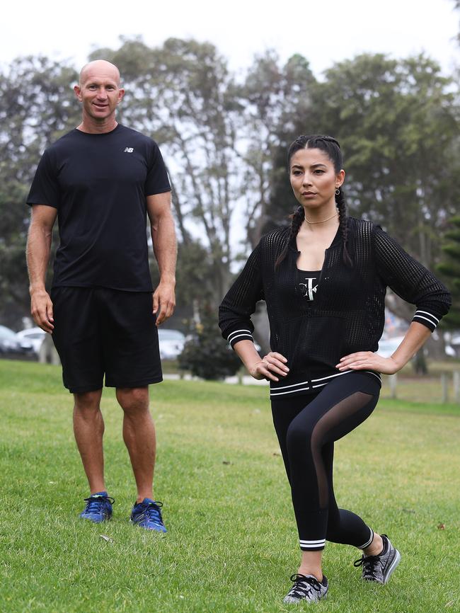 Gomes shows Adam MacDougall how she works out. Picture: Brett Costello