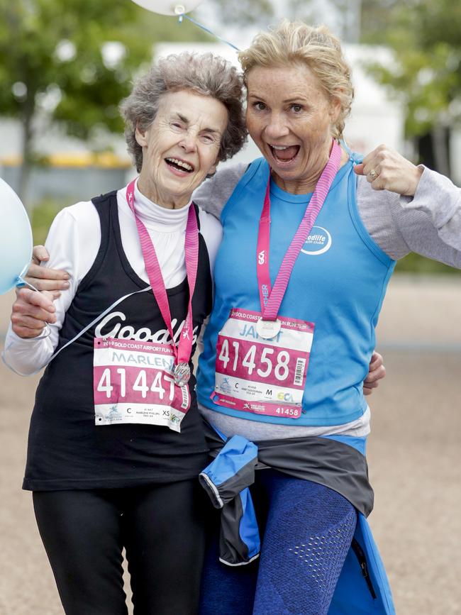 Ashmore’s Marlene Phillips, who is turning 80 on Sunday, celebrates with a friend at the finish line of the Gold Coast Airport Fun Run. Picture: Tim Marsden