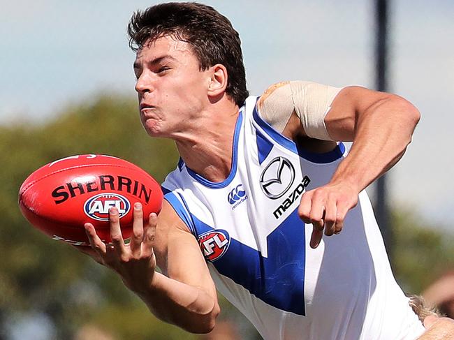 AFL: JLT Community Series match North Melbourne vs. Melbourne, Twin Ovals, Kingston, Tasmania: North Melbourne's Luke Davies-Uniacke gets his handball away under pressure. Picture: LUKE BOWDEN
