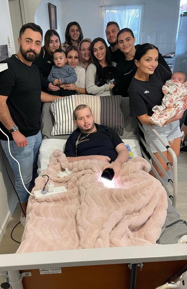 Joseph Tahan in hospital surrounded by his family. Picture: Supplied